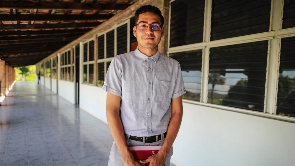 Antonio Abelez stands outside a seminary building