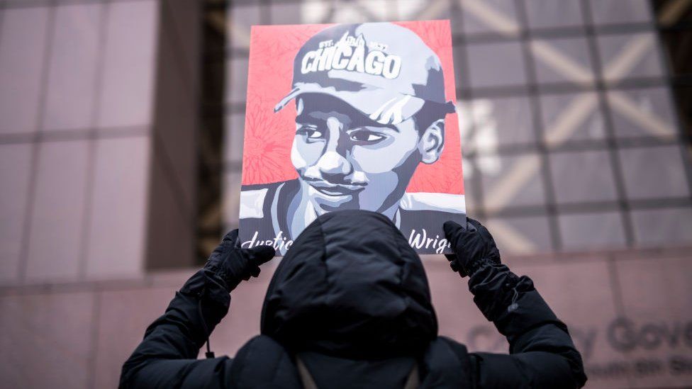 A demonstrator holds up a portrait of Daunte Wright outside the Hennepin County Government Center during the sentencing hearing for former Brooklyn Center police officer Kim Potter