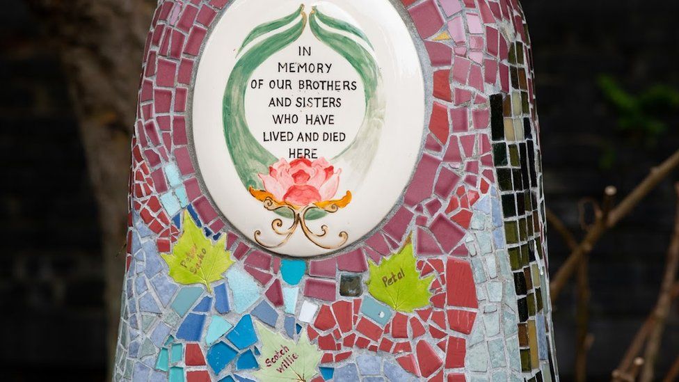 A mosaic memorial on a bench, paying tribute to 'our brothers and sisters who have lived and died here'