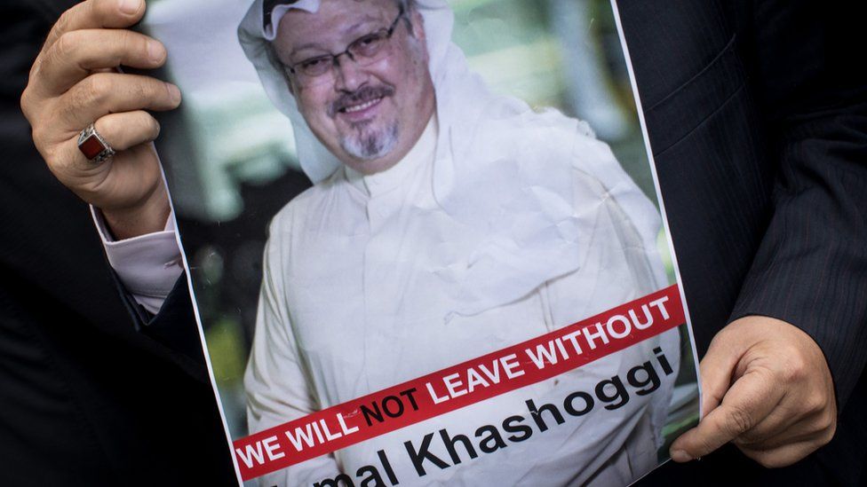 A man holds a poster of Saudi journalist Jamal Khashoggi