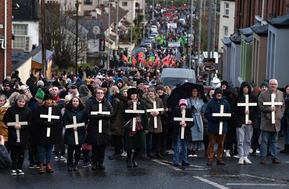 Families of the victims and supporters hold crosses as they mark the 50th anniversary of Bloody Sunday, in Londonderry, Northern Ireland.