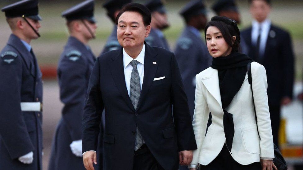 South Korea's President Yoon Suk Yeol and his wife Kim Keon Hee disembark from an aircraft after landing at London Stansted Airport on November 20, 2023