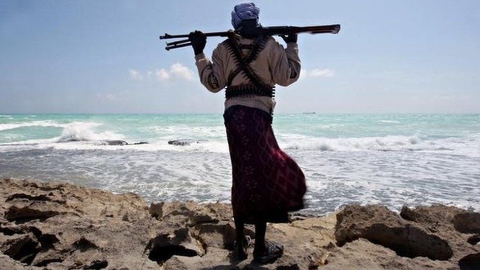 An armed Somali pirate along the coastline (January 2010)