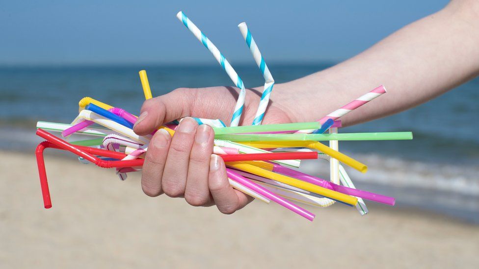 A person holding straws