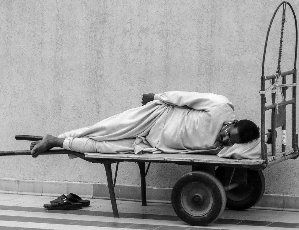 A man takes a nap on a trolley