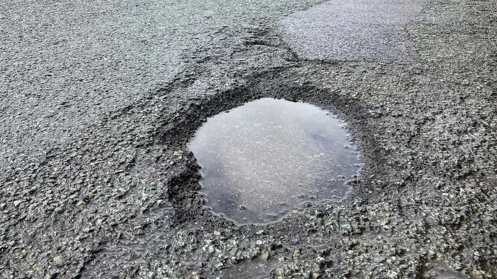 A pothole filled with water