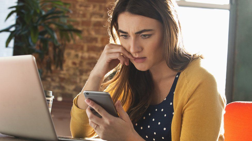 Woman looks at her phone