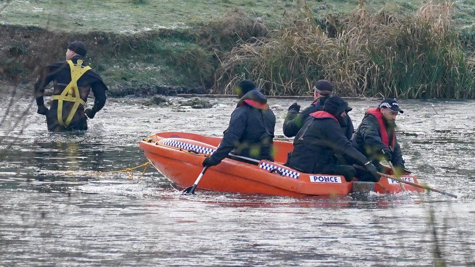 Police break the ice on the lake at Babbs Mill Park in Kingshurst