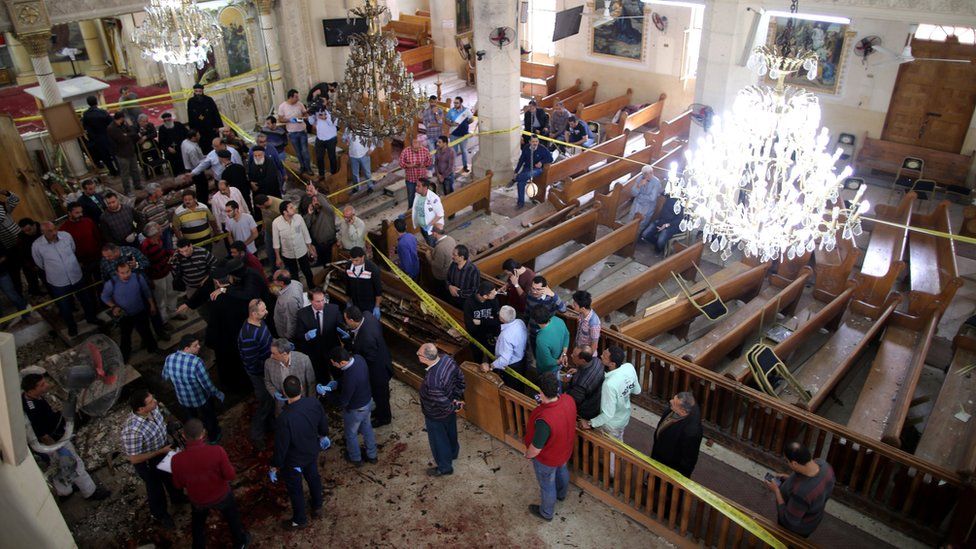 Security personnel investigate the scene of a bomb explosion inside Mar Girgis church in Tanta