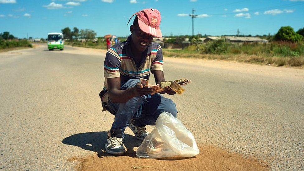 Mayibongwe Khumalo repairing a pothole