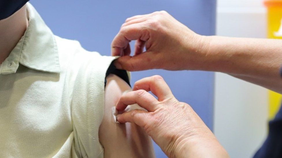 Pressure applied to person's arm after vaccination