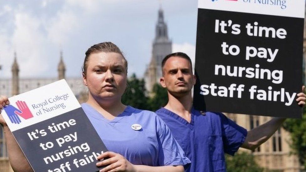 Nurses with placards outside the Royal College of Nursing (RCN) in Victoria Tower Gardens, London