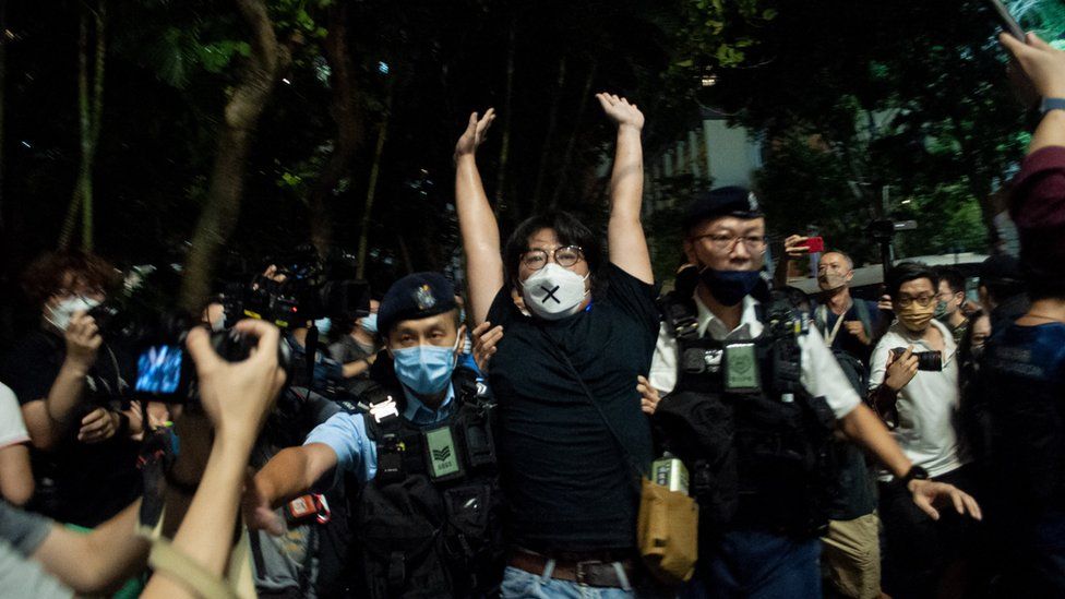 An activist is arrested in Hong Kong on Saturday