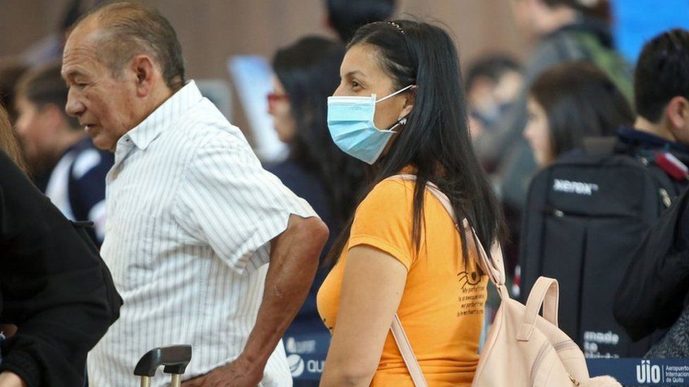 A passenger wears a protective mask at Mariscal Sucre International Airport, regarding the spread of the COVID-19 virus worldwide, in Quito, on March 1, 2020.