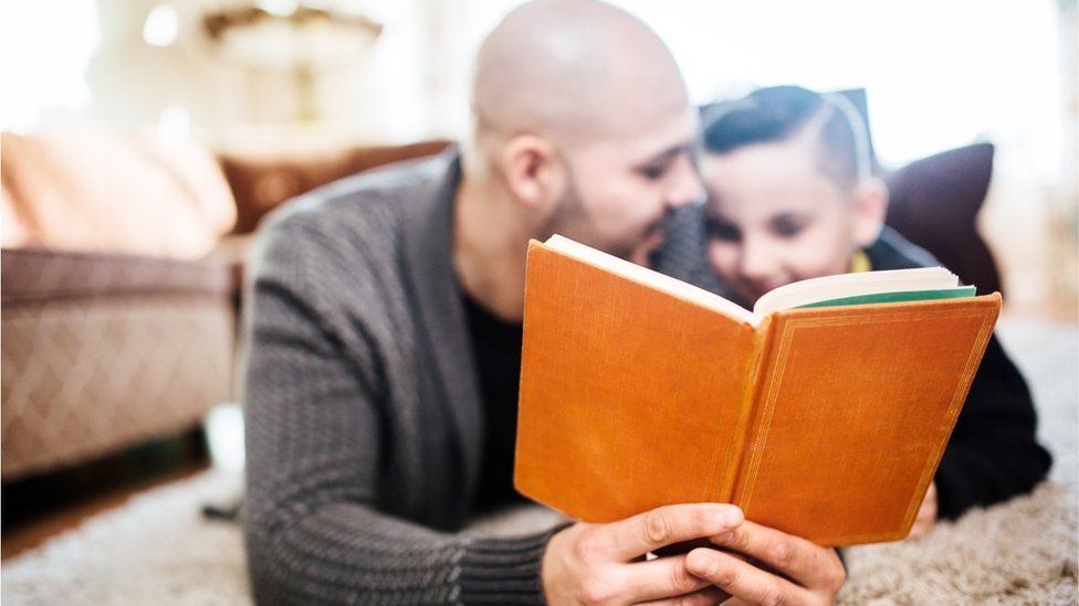 Father and son reading