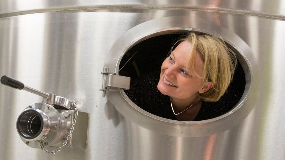 Floriane Eznack peeks out from a large silver tank