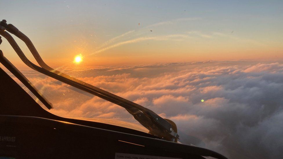 View from helicopter above the clouds