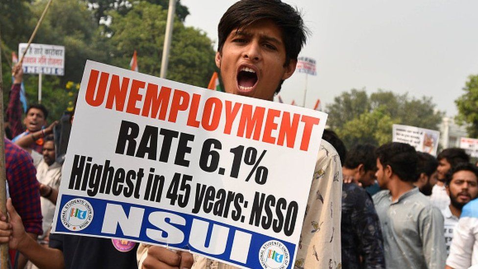 National Students Union of India (NSUI) members hold placards and shout slogans against Prime Minister Narendra Modi and Bharatiya Janata Party (BJP) as they take out a mock funeral for the economy, rising unemployment, and demonetisation at Connaught Place, on November 8, 2019 in New Delhi, India.