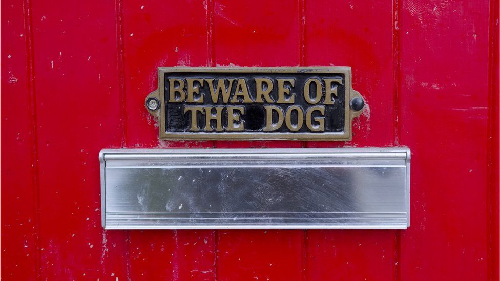Postbox with beware of the dog sign
