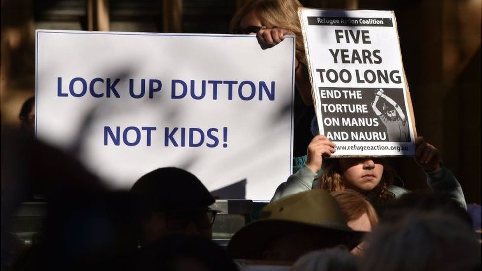 A protest about offshore detention in Sydney in July says: "LOCK UP DUTTON NOT KIDS"
