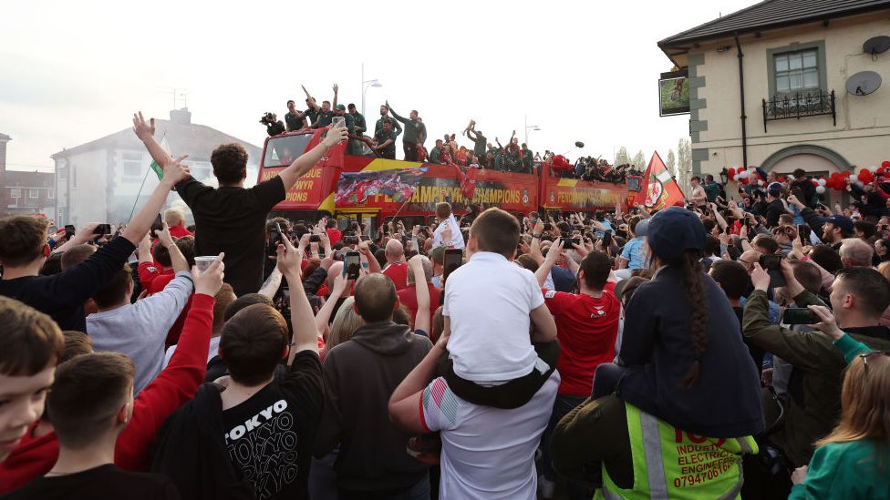 Children sat on shoulders to get a glimpse of their favourite Wrexham players as they went past