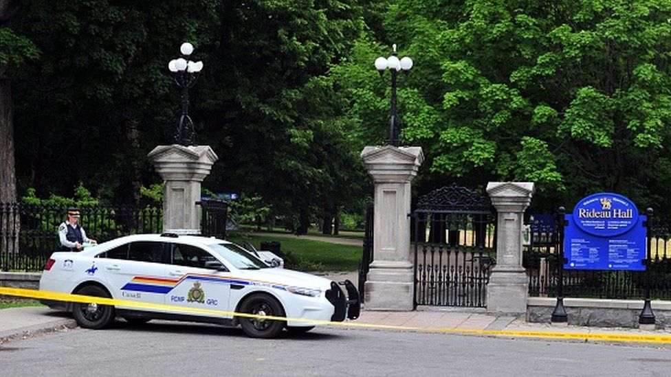 The main entrance to Rideau Hall in Ottawa, with a police car parked outside