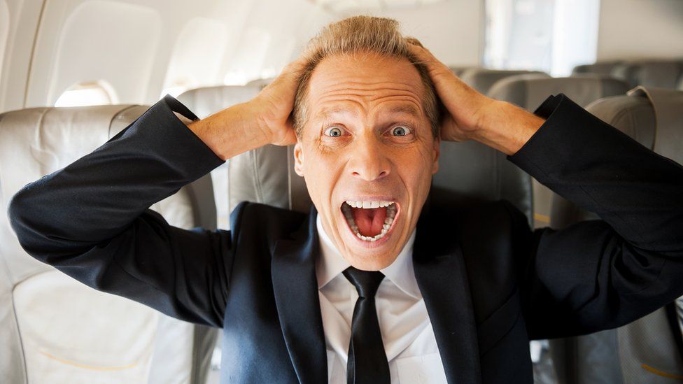 Stressed businessman on plane