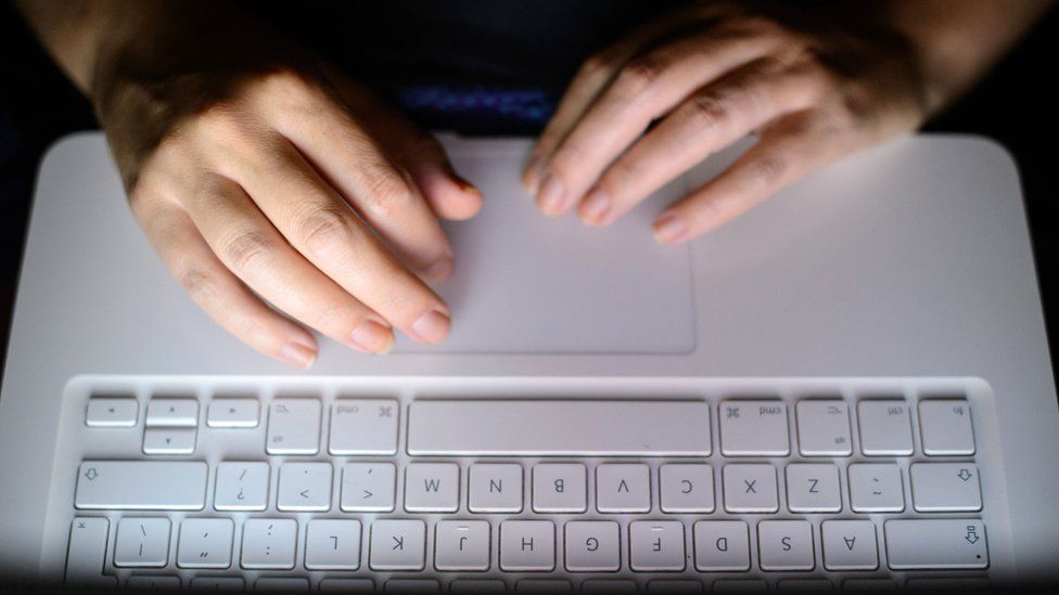 Laptop computer. Hands typing on the keyboard of a laptop computer.