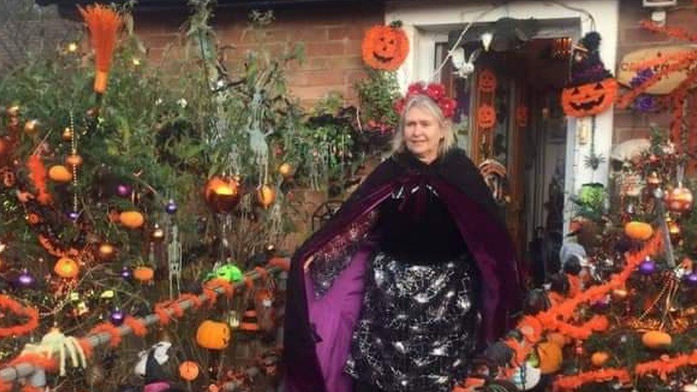 Lynda Starkey in front of her Halloween-decorated home