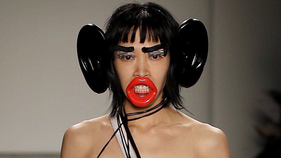 A model wearing accessories such as large ears, large lips and large eyebrows, which has been labelled 'racist'.