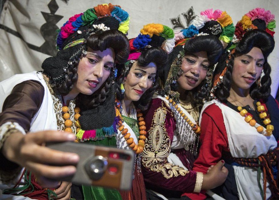 Young Amazigh women pose for a selfie during the annual Engagement Moussem festival near the village of Imilchil in central Morocco's high Atlas Mountains - 21 September 2019