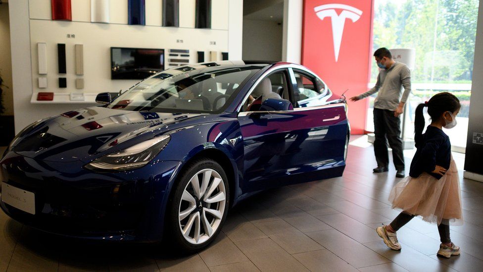 Visitors at a Tesla showroom in Beijing