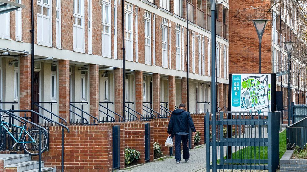 man walking through housing estate