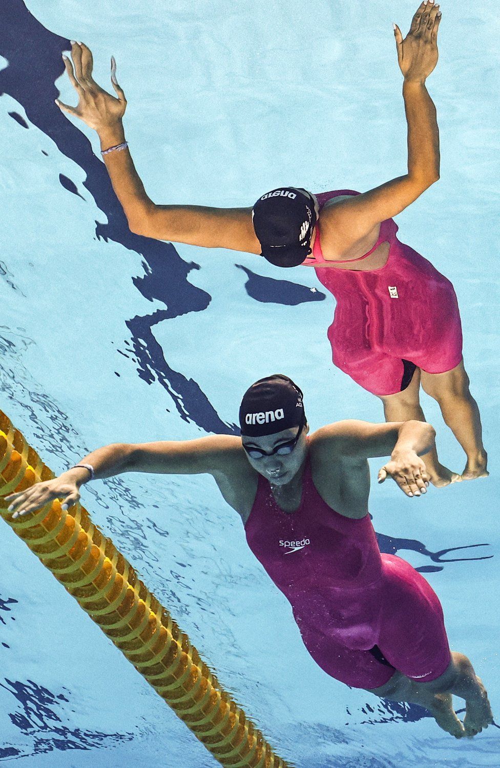 A woman in a pink swimsuit swimming on 26 July 2023