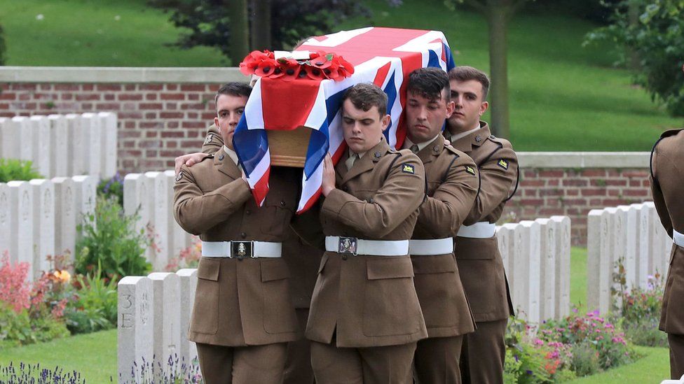 Soldiers of the Princess of Wales Royal Regiment carry one of the coffins of two young privates and an unknown soldier
