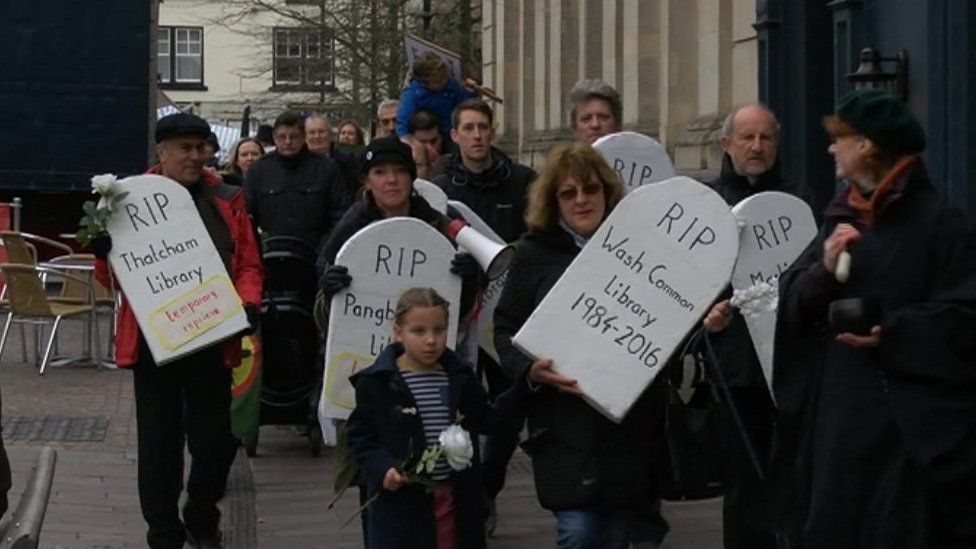 Library protest with gravestones