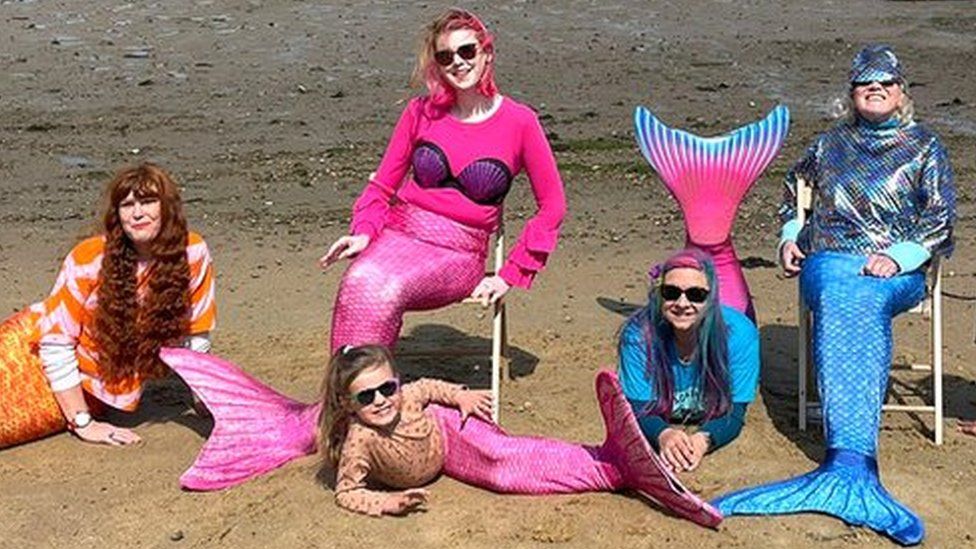 swimmers dressed as mermaids