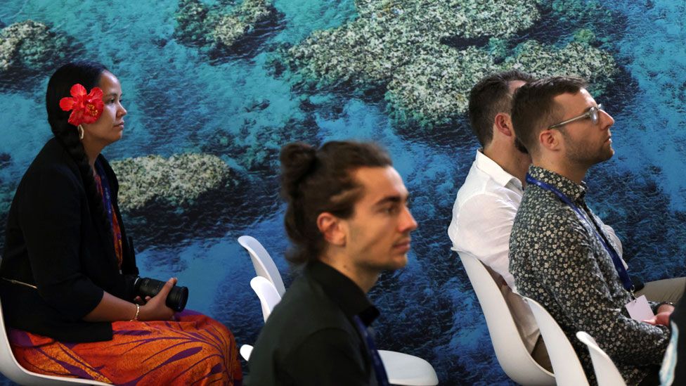Participants attend a presentation at the Moana Blue Pacific pavilion of Pacific islands prior to the opening ceremony of the UNFCCC COP28 Climate Conference at Expo City Dubai on November 30, 2023 in Dubai, United Arab Emirates
