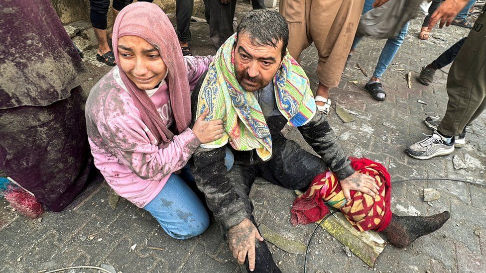 An injured man and a crying woman are seen in Rafah, southern Gaza, after an Israeli air strike. Photo: 12 December 2023