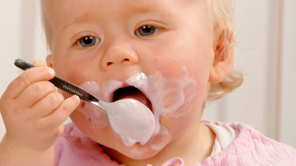 baby eating yoghurt