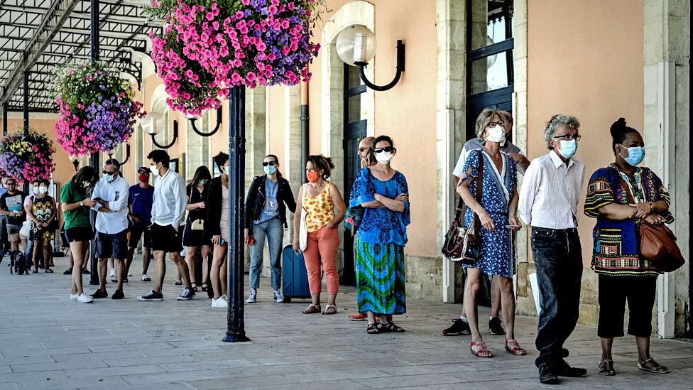 People queue to be screened outside the Arcachon railway station in France.