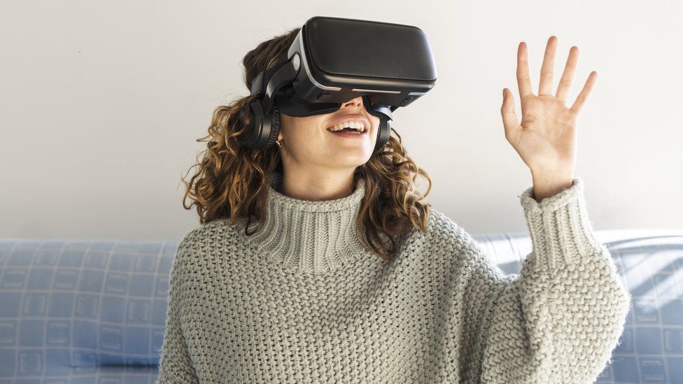 A woman wearing VR goggles