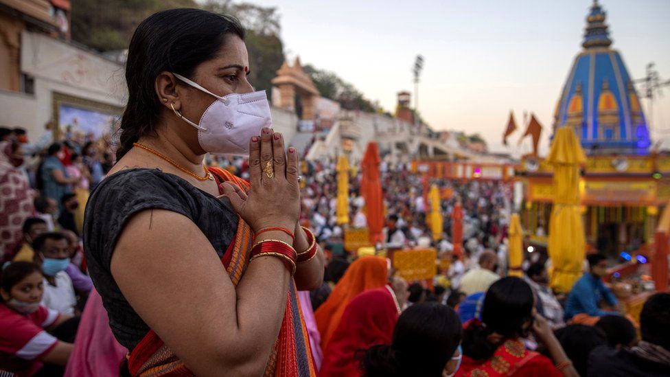 Devotees gather for an evening prayer on the banks of Ganges river during Kumbh Mela in Haridwar, India