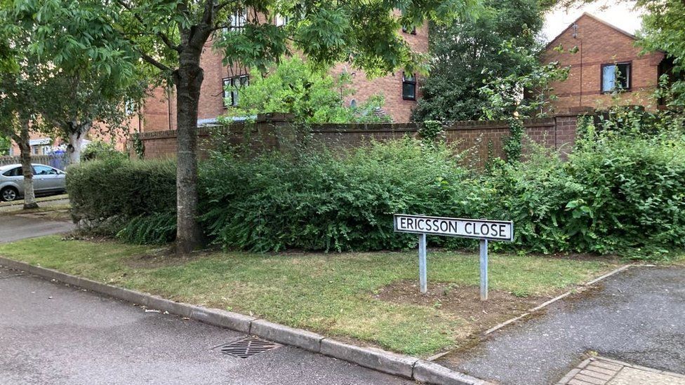 Residential street in new housing estate with "Ericcson Close" sign