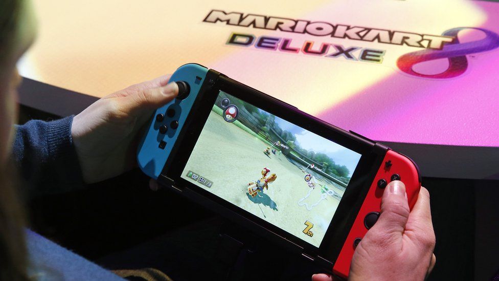 A visitor plays the "Mario Kart 8 Deluxe" video game on a Nintendo Switch games console during the new console's unveiling by Nintendo Co on January 13, 2017 in Paris, France.