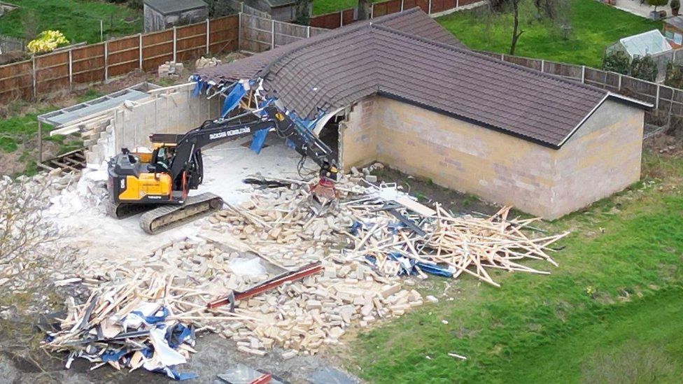 Work continues to demolish an unauthorised spa pool block at the home of Hannah Ingram-Moore, the daughter of the late Captain Sir Tom Moore, at Marston Moretaine, Bedfordshire