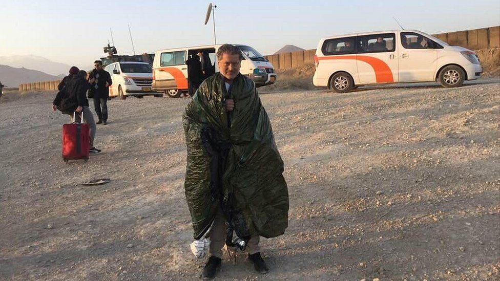 Vasileios wrapped in a battery-powered blanket