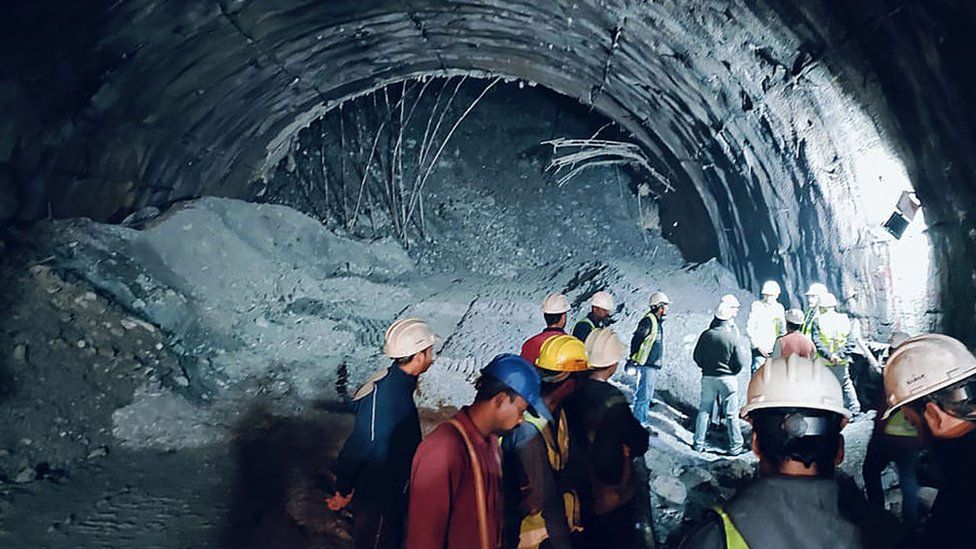 In this photograph taken on November 12, 2023, rescue workers gather at the site after a tunnel collapsed in the Uttarkashi district of India's Uttarakhand state. Rescue workers in northern India said on November 13 they had made contact with 40 workers trapped for over 24 hours after the road tunnel they were building collapsed. (Photo by AFP) (Photo by -/AFP via Getty Images)