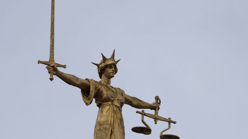 A statue of the Scales of Justice stands above the Old Bailey on January 19, 2021 in London, England