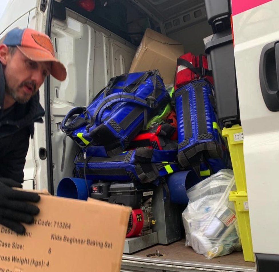 The team loading supplies onto the vehicle